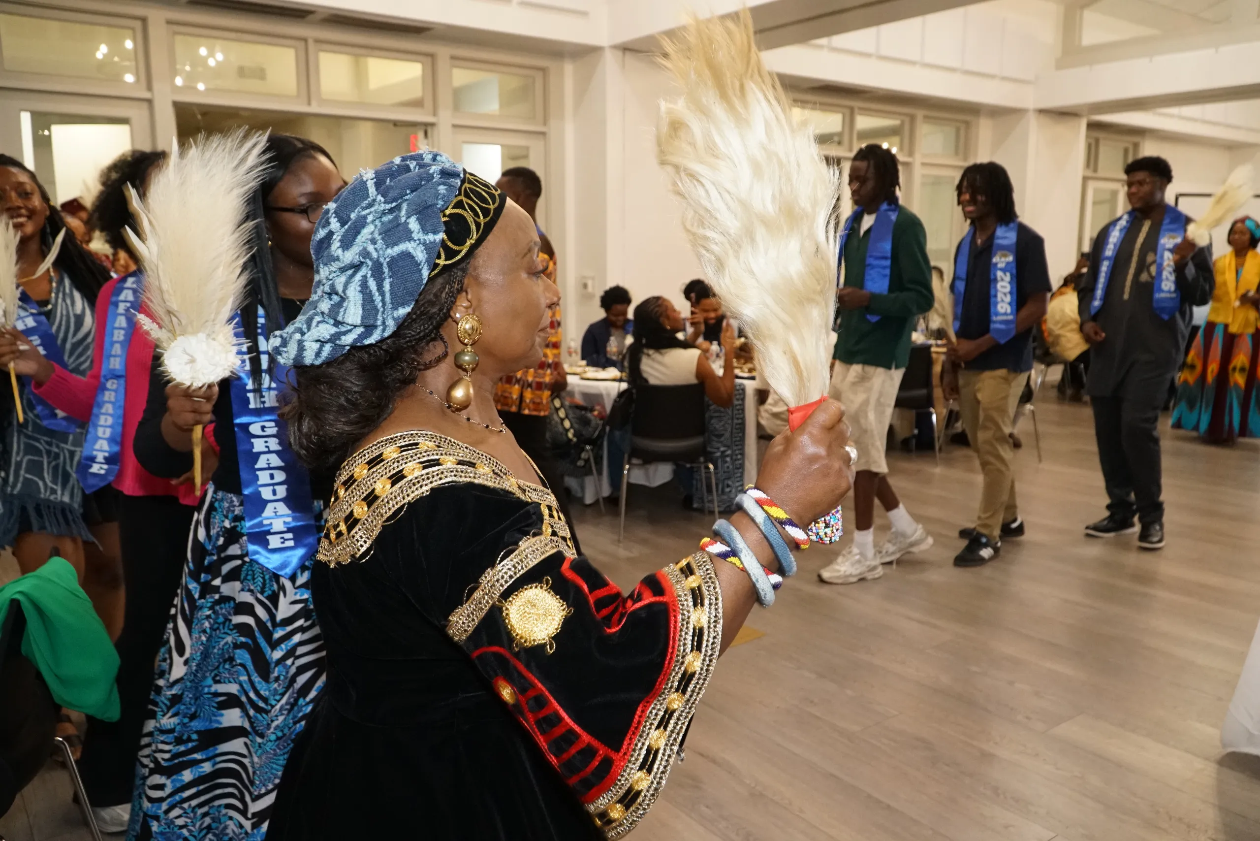 A LAFABAH elder in a feathered Bamileke ceremonial headdress and indigo Ndop regalia