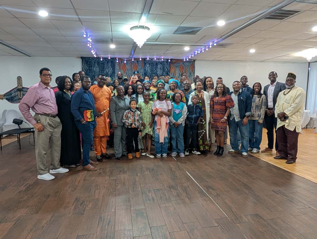 LAFABAH families — elders, parents, and children — gathered for a group photograph in front of an Ndop cloth backdrop